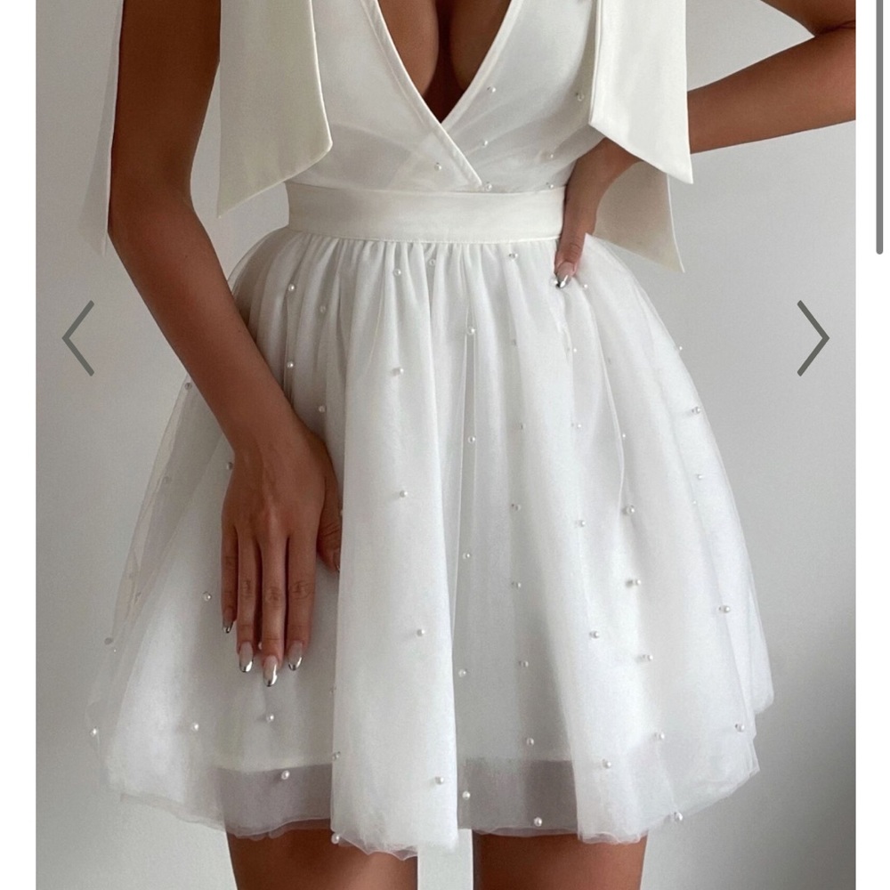 Brand new white dress with pearls perfect for bridal event, never worn has tag